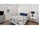 Cozy bedroom featuring a floral-patterned comforter, a modern nightstand, and a bright window at 2658 Meadowedge Loop, St Cloud, FL 34772