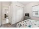A bedroom is decorated with a bed, dresser, and closet at 2658 Meadowedge Loop, St Cloud, FL 34772