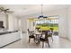 Bright dining area with backyard views, stylish pendant lighting, and a contemporary table setting at 2658 Meadowedge Loop, St Cloud, FL 34772