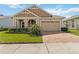 Charming one-story home featuring a two-car garage, paver driveway, and well-manicured landscaping at 2658 Meadowedge Loop, St Cloud, FL 34772