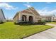 One-story home with well-maintained lawn and manicured landscaping, set against a bright blue sky at 2658 Meadowedge Loop, St Cloud, FL 34772