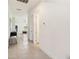 Bright hallway with tile flooring leading to an open-concept living area and backyard view at 2658 Meadowedge Loop, St Cloud, FL 34772