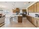 A spacious kitchen features wood cabinets, a large island, and stainless steel appliances at 2658 Meadowedge Loop, St Cloud, FL 34772