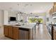 Open-concept kitchen featuring a large island, stainless steel appliances, and access to the living area at 2658 Meadowedge Loop, St Cloud, FL 34772