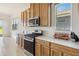 Kitchen with stainless appliances, stylish cabinetry, and plenty of counter space at 2658 Meadowedge Loop, St Cloud, FL 34772