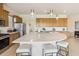 A spacious kitchen features wood cabinets, a large island with seating, and modern appliances at 2658 Meadowedge Loop, St Cloud, FL 34772