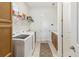 A well-organized laundry room features modern washer and dryer, plus ample storage at 2658 Meadowedge Loop, St Cloud, FL 34772