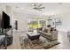 Open-concept living space with backyard views, a modern ceiling fan, and neutral décor at 2658 Meadowedge Loop, St Cloud, FL 34772