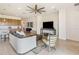 Open-concept living room featuring a stylish sofa, media console, and an accent chair with wood trim at 2658 Meadowedge Loop, St Cloud, FL 34772
