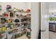 Large walk-in pantry with ample shelving, perfect for organized storage of groceries and kitchen essentials at 2658 Meadowedge Loop, St Cloud, FL 34772