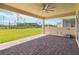 Spacious covered back patio with a brick paver floor and a beautiful yard view at 2658 Meadowedge Loop, St Cloud, FL 34772