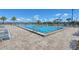 Resort-style lap swimming pool with paved deck, plenty of lounge chairs and tropical landscaping at 2658 Meadowedge Loop, St Cloud, FL 34772