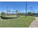 Manicured putting green area amidst lush landscaping and paved walkways within a gated community at 2658 Meadowedge Loop, St Cloud, FL 34772