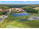 Aerial view of residential area shows houses, a large pond, and part of a manicured golf course at 2724 Camden Ln, Davenport, FL 33837