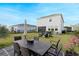 Backyard offers a large dining table, chairs, and manicured lawn perfect for outdoor entertaining at 2724 Camden Ln, Davenport, FL 33837