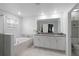 Bright bathroom featuring a soaking tub, double vanity, and ample lighting at 2724 Camden Ln, Davenport, FL 33837