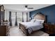 Well-lit bedroom with a large bed, matching nightstands, a dresser, and a ceiling fan at 2724 Camden Ln, Davenport, FL 33837