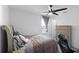 Gaming-themed bedroom featuring a sleek desk setup, comfortable bed, and modern ceiling fan at 2724 Camden Ln, Davenport, FL 33837