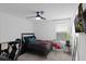 Stylish bedroom with a modern ceiling fan, comfortable bed, and ample natural light at 2724 Camden Ln, Davenport, FL 33837
