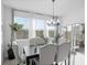 Formal dining room with modern chandelier, ample natural light, and sliding glass doors to the patio at 2724 Camden Ln, Davenport, FL 33837