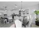 Bright dining space with modern chandelier and seating, complemented by a view of the sleek, stylish kitchen at 2724 Camden Ln, Davenport, FL 33837