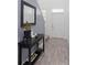 Stylish entryway with wood-look tile flooring, console table with decor, and plenty of natural light at 2724 Camden Ln, Davenport, FL 33837