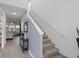 Entryway leading to a carpeted staircase and open-concept living space with wood-look tile at 2724 Camden Ln, Davenport, FL 33837