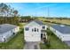 Beautiful two-story home with manicured lawn, palm trees, and a paver driveway providing curb appeal at 2724 Camden Ln, Davenport, FL 33837