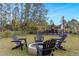 Backyard view showcases a fire pit with Adirondack chairs offering cozy outdoor gatherings at 2724 Camden Ln, Davenport, FL 33837