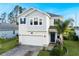 Charming two-story home with brick driveway, blue shutters, and well-maintained landscaping at 2724 Camden Ln, Davenport, FL 33837