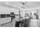 Contemporary kitchen features a large center island with bar seating and stainless steel appliances at 2724 Camden Ln, Davenport, FL 33837