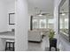 Open-concept view with tile flooring, desk, and entryway, leading into a naturally lit living room at 2724 Camden Ln, Davenport, FL 33837