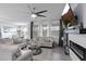 Bright living room featuring a modern fireplace, ceiling fan, and plush seating arrangement at 2724 Camden Ln, Davenport, FL 33837