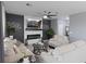 Comfortable living room featuring a modern fireplace, ceiling fan, and plush seating arrangement at 2724 Camden Ln, Davenport, FL 33837