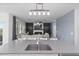 Bright living area features seamless transition from kitchen to living room with a modern fireplace and entertainment center at 2724 Camden Ln, Davenport, FL 33837