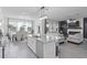 Open concept living space with a modern kitchen island that flows into the living room with a fireplace at 2724 Camden Ln, Davenport, FL 33837