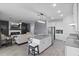 Spacious open-concept living space features a modern kitchen, living area with fireplace, and stylish decor at 2724 Camden Ln, Davenport, FL 33837