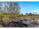 Outdoor dining area featuring a wooden table, chairs, and a garden, perfect for enjoying meals outside at 2724 Camden Ln, Davenport, FL 33837