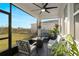 Screened-in patio with comfortable seating and views of the backyard at 2724 Camden Ln, Davenport, FL 33837