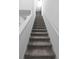 Clean staircase with carpeted steps and white railings leading to upper level, adding architectural interest at 2724 Camden Ln, Davenport, FL 33837