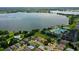 Overhead view of a lakeside community boasting a clubhouse, pool, tennis courts, and attractive residential homes at 2885 Attwater Loop, Winter Haven, FL 33884
