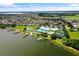 Beautiful aerial view of a waterfront community with a clubhouse, pool, docks, and meticulously landscaped grounds at 2885 Attwater Loop, Winter Haven, FL 33884