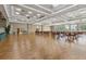 Large community ballroom features wood flooring, tray ceiling, large windows and tables with chairs at 2885 Attwater Loop, Winter Haven, FL 33884
