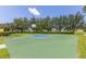 Outdoor community basketball court with new court, hoop, lights, and well-kept green grass all around at 2885 Attwater Loop, Winter Haven, FL 33884