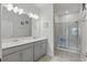 Modern bathroom with double vanity, ample lighting, and a glass-enclosed shower at 2885 Attwater Loop, Winter Haven, FL 33884