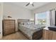 Bright bedroom features a ceiling fan, large window, and neutral decor at 2885 Attwater Loop, Winter Haven, FL 33884