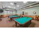 Community billiard room features three pool tables, wood trim and neutral decor at 2885 Attwater Loop, Winter Haven, FL 33884