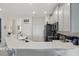 Kitchen with white countertops, stainless steel appliances, and bar seating at 2885 Attwater Loop, Winter Haven, FL 33884