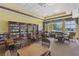 Community library with extensive bookshelves, tables and chairs, and large windows at 2885 Attwater Loop, Winter Haven, FL 33884