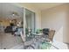 Enclosed patio with a grill, table, and seating area with open access to the living area at 2885 Attwater Loop, Winter Haven, FL 33884